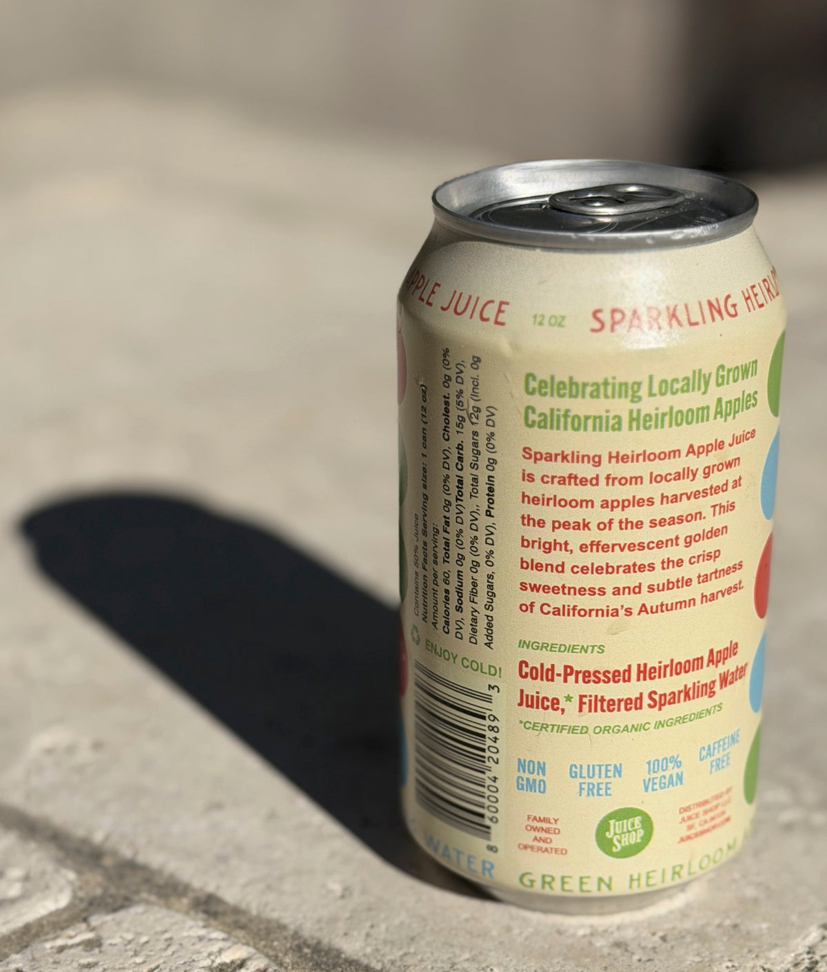 Can of sparkling heirloom apple juice on a concrete surface