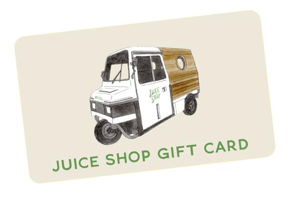 The gift card displays an illustration of a small three-wheeled delivery vehicle with Juice Shop on its side. Set against a beige backdrop, it reads Online Juice Shop Gift Card, ideal for online orders or in-store purchases.